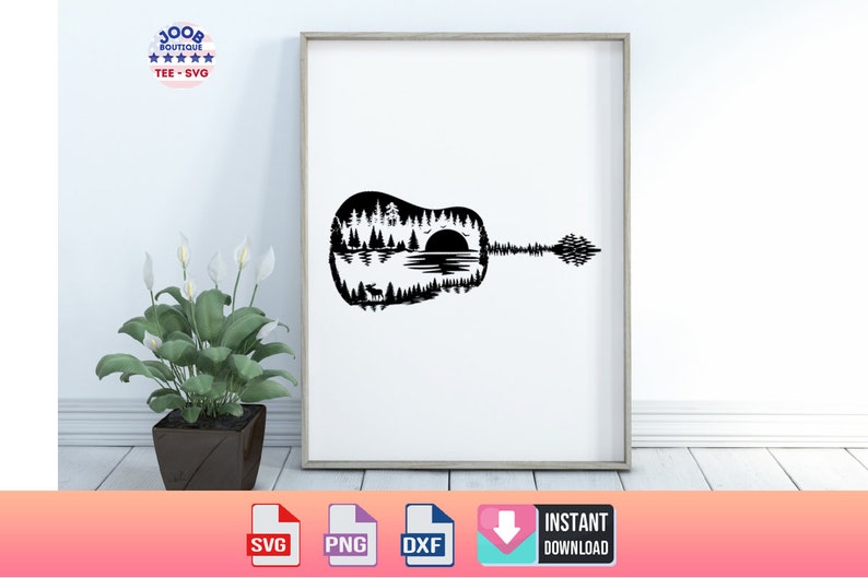 May include: Black and white framed art print featuring a guitar silhouette with a nature scene inside. The design includes trees, a lake, a setting sun, and a deer. The print is displayed on a white wall.