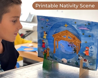 May include: A blue and white printable nativity scene with a cutout for the manger. The scene includes a star, clouds, and a donkey. The scene is on a wooden stand.  ©MR-MINTZ.COM