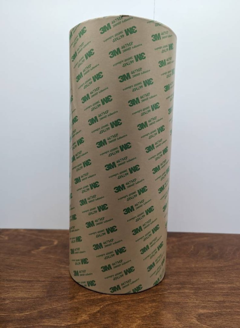 May include: A roll of brown tape with green text that reads "3M 467MP 20051P Adhesive".