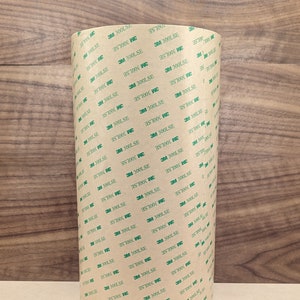 May include: A roll of brown tape with green text that reads "3M 300LSE".
