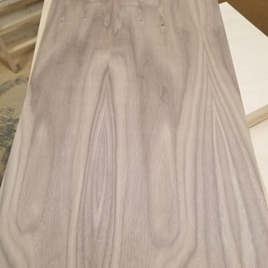May include: A sheet of light brown wood veneer with a natural wood grain pattern. The veneer has a smooth surface and is ready for woodworking projects.