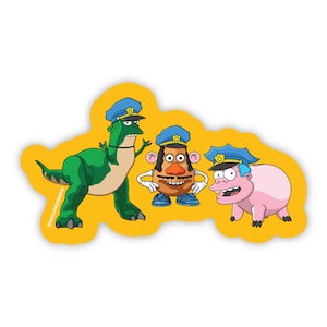 May include: A sticker featuring a green dinosaur, a brown potato-shaped character, and a pink pig-like character, all wearing blue police hats with gold badges. The characters are set against a solid yellow background with the text @SKILLIAMSKRIBBLEZ.