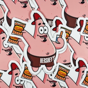 May include: A set of pink cartoon character stickers featuring a character wearing a brown hat and holding a package of hot dogs. The character is wearing brown shorts with the text "Hershey's" printed on the front.