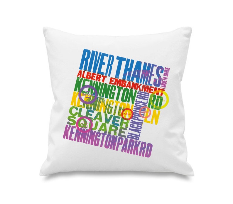 May include: White square cushion featuring multi-coloured text with place names such as "River Thames", "Kennington", and "Cleaver Square". The text is in various colours. A decorative home item.