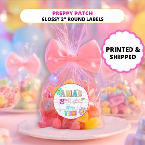 May include: A clear cellophane bag tied with a pink bow, filled with colorful gummy candies. A round label reads "ABIA'S 8th Birthday" with a floral design. The text "PREPPY PATCH GLOSSY 2" ROUND LABELS" is at the top.