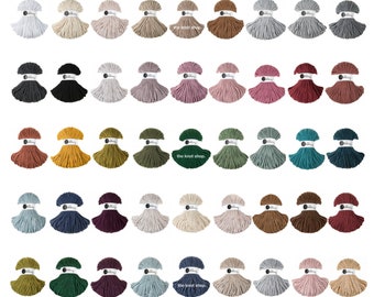 May include: Assortment of 50 spools of cotton rope in various colours, including natural, black, grey, pink, red, yellow, green, blue, brown, and purple. The spools are arranged in five rows of ten spools each. The text "The Knot Shop" appears on two of the spools.