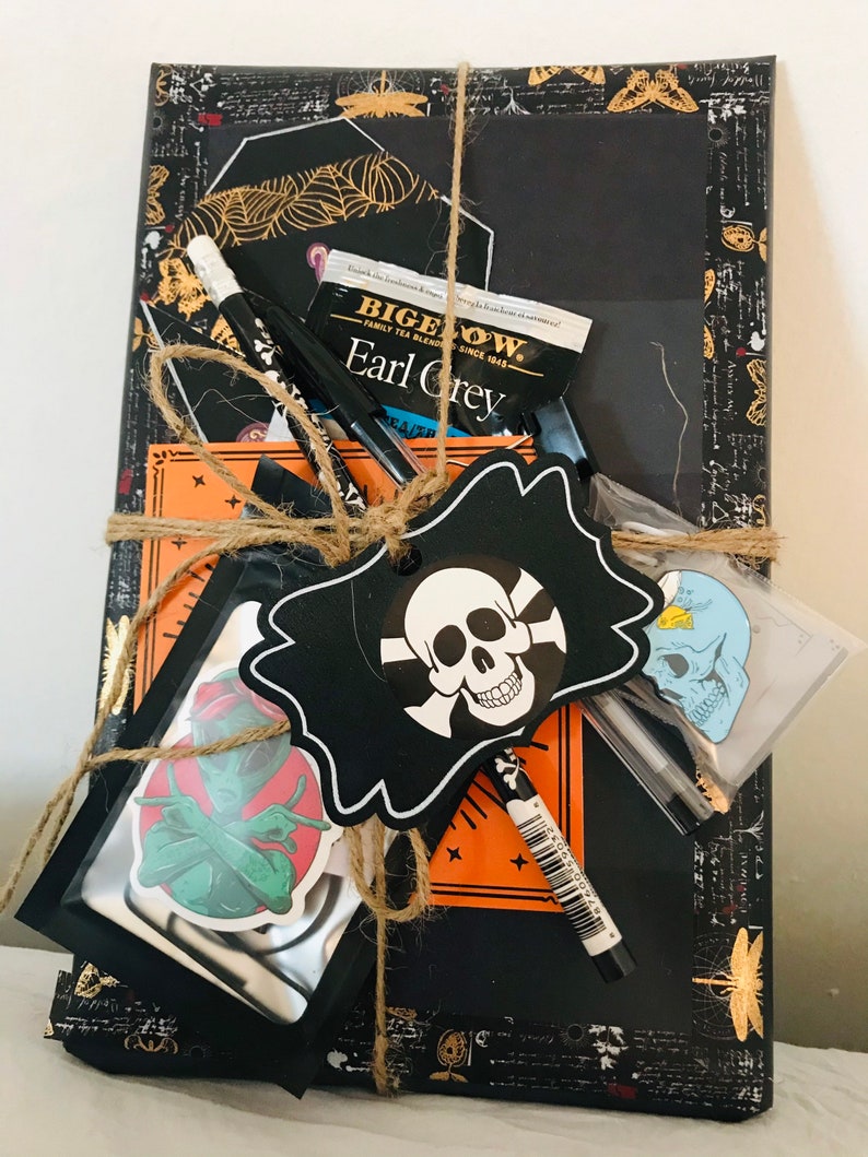 A book packet with pens, tea and a book from GothbyTarina on Etsty