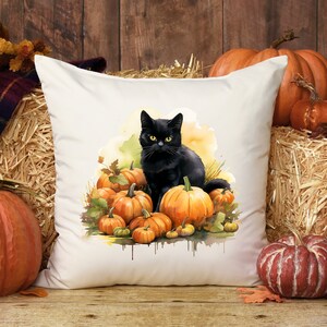 May include: A white cushion featuring a black cat perched atop a collection of orange pumpkins. The cat has yellow eyes and is surrounded by autumn leaves.