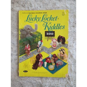 May include: A vintage coloring book featuring Lucky Locket Kiddle dolls. The cover shows a cartoon elephant in a cage, a zoo sign, and several dolls in various scenes. The book is titled "Lucky Locket Kiddle Zoo" and is a Whitman coloring book.