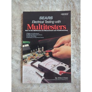 May include: A book titled "Electrical Testing with Multitesters" by Alvin J. Evans. The book cover features a person using a multimeter to test a circuit board. The book is published by Master Publishing, Inc.