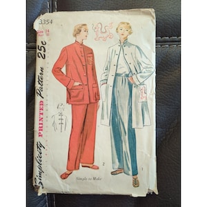 May include: Vintage Simplicity sewing pattern for a two-piece outfit. The pattern is printed on white paper with a red dragon illustration. The pattern is for size 14, bust 32, and costs 25 pence. The outfit includes a red jacket with a mandarin collar and matching trousers, and a white jacket with a blue shirt and matching trousers.
