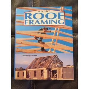 May include: A book titled "Basic Roof Framing" by Benjamin Barnow. The cover features a photo of a worker on a roof framing a house. The book cover is blue with white text.