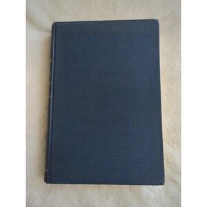 May include: A dark blue hardcover book with a plain cover.
