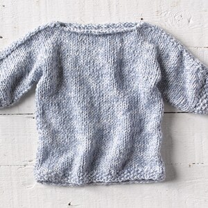 One of a kind; hand knit baby sweater in lovely shade of blues and creams. Size 12-18 months. This sweater has a beautiful drape.