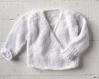 One of a kind; hand knit baby/toddler wrap sweater. Soft white poly cotton yarn. Size 18 months - 2T. Great for all seasons.