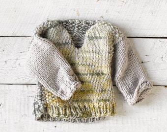One of a kind, hand knit baby sweater.  A blended yarn with waves of yellow, greens and gray. Size 0-6 months. Soft and Cozy!