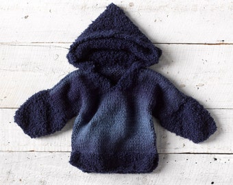 One of a kind; hand knit baby hoodie size 18 -24 months (up to 2T). I used multiple yarns from England to create this luxurious sweater.