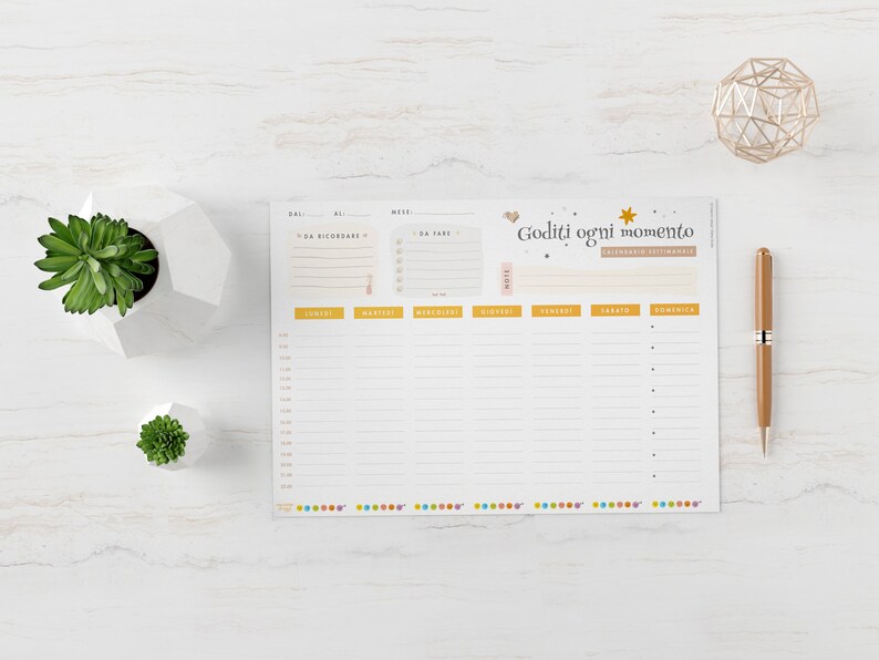 May include: A weekly planner with the text "Goditi ogni momento" in Italian. The planner has sections for each day of the week, with time slots and space for notes. A gold pen and geometric decoration are on the right.