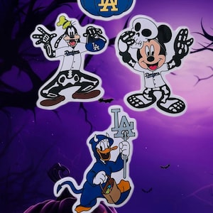 May include: Five Halloween-themed stickers featuring Mickey Mouse, Minnie Mouse, Goofy, Donald Duck, and a skeleton Mickey Mouse. Each sticker features the characters dressed in baseball uniforms with the Los Angeles Dodgers logo and the text "Dodgers".