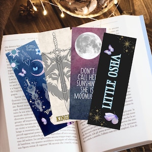 May include: Four different bookmark designs with a fantasy theme. The bookmarks feature a wolf and sword, a moon, a butterfly, and a quote that reads "Don't call her sunshine, she is moonlight".