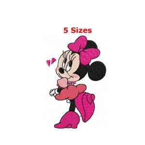May include: An embroidered design of Minnie Mouse in a side profile, wearing a pink bow, dress, and shoes. The text "5 Sizes" is above the character. Two pink hearts float near her head.