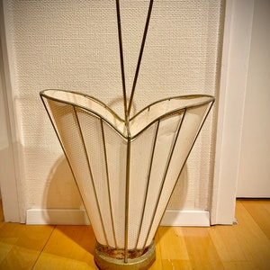 May include: A vintage metal umbrella stand with a white, perforated, cone-shaped base and a metal handle.