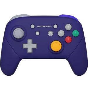Pode incluir: Um controlador Nintendo Switch roxo com um botão amarelo e o texto "SWITCHCUBE" na frente.