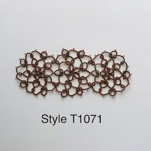 May include: A brown crocheted lace trim with a repeating floral pattern. The trim is made up of three connected sections. The text "Style T1071" is printed below the trim.