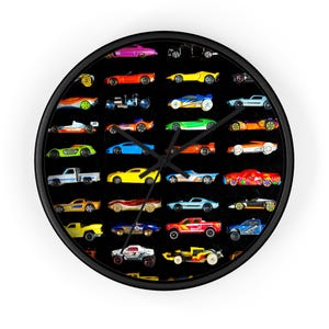 May include: A black and white wall clock with a black frame. The clock face is covered with a collage of colorful toy cars. The cars are arranged in rows and columns, and they are all different colors and styles.