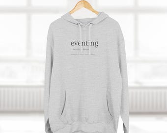 May include: A gray hoodie with a pocket and the text "eventing [ˈɛvɛntɪŋ] noun:  along a 3-ways over 3 days" printed on the front.