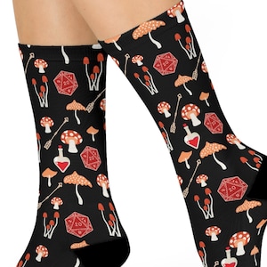 May include: A pair of black socks with a repeating pattern of red and orange mushrooms, dice, and potion bottles.