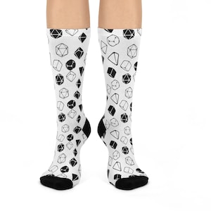 May include: A pair of white socks with a black and white dice pattern. The socks are made of a soft, comfortable material and are perfect for everyday wear.