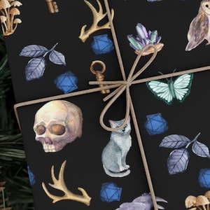 May include: Black gift wrap with a repeating pattern of various magical and whimsical illustrations, including a skull, a cat, a butterfly, a key, a raven, mushrooms, and a crystal. The gift wrap is tied with a brown string.