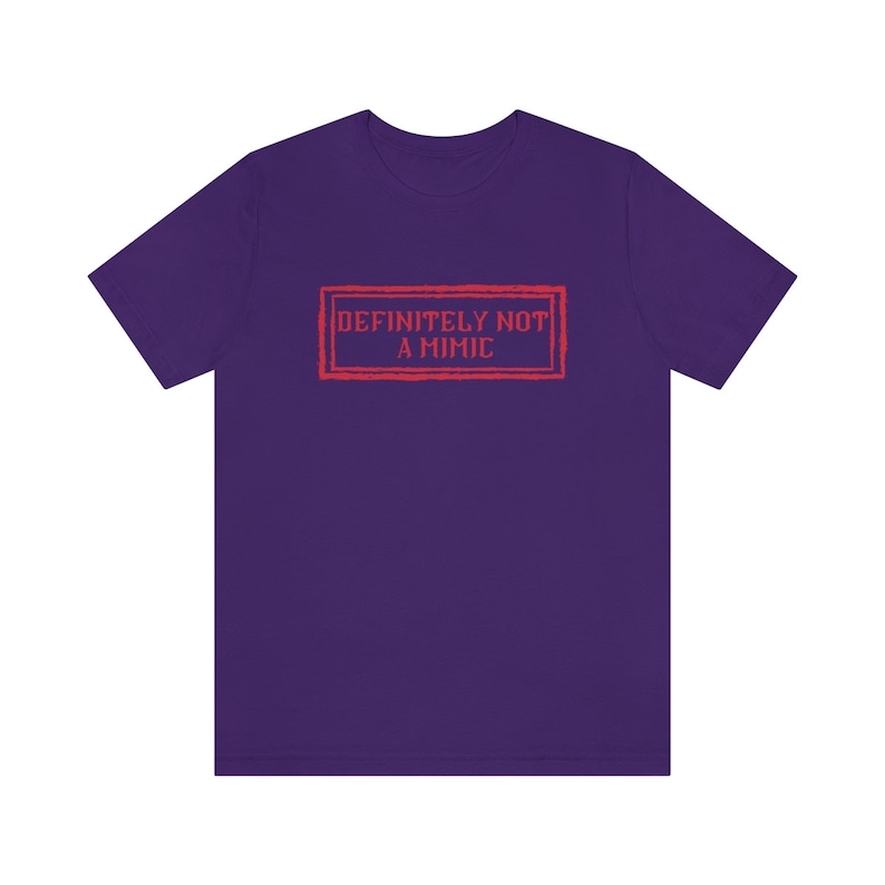 May include: Purple t-shirt with a red rectangular stamp that says "DEFINITELY NOT A MIMIC".
