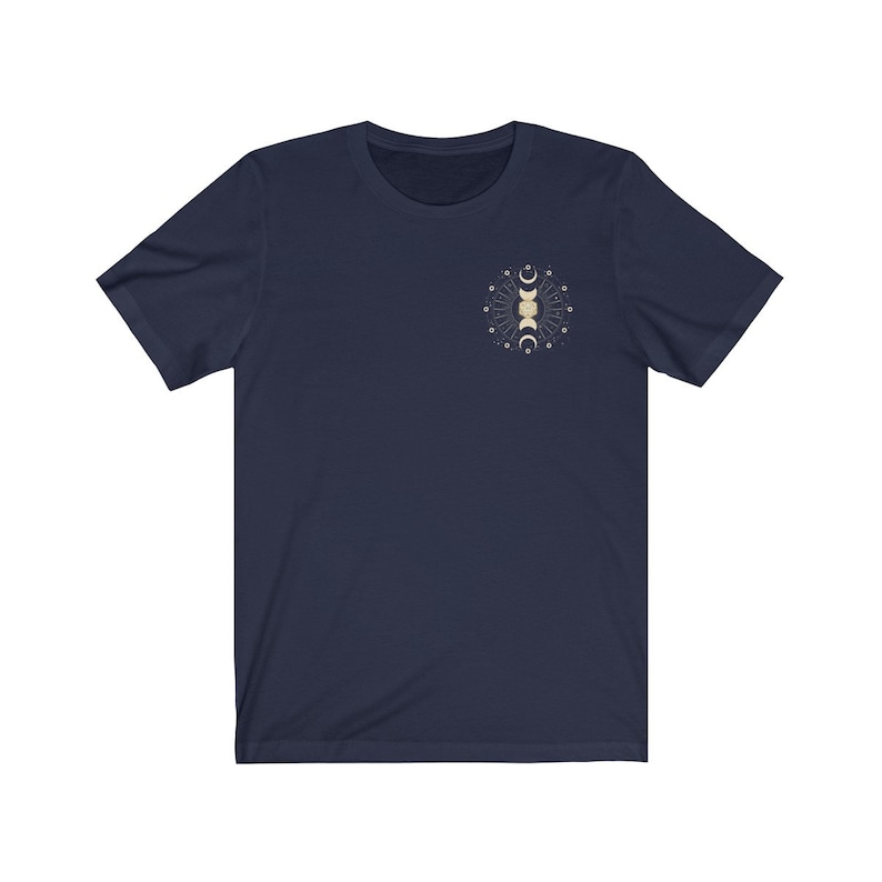 May include: A navy blue short-sleeved t-shirt with a gold moon and stars graphic on the front.