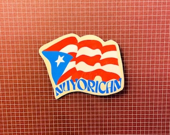 May include: A sticker with a red, white, and blue Puerto Rican flag design. The sticker says "Nuyorican" in white letters.