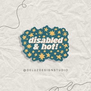 May include: A sticker with the text "disabled & hot!" in white and orange, surrounded by yellow stars on a teal background. The sticker has a wavy edge and is on a textured, off-white surface. The text "@DELUZDESIGNSTUDIO" is at the bottom.