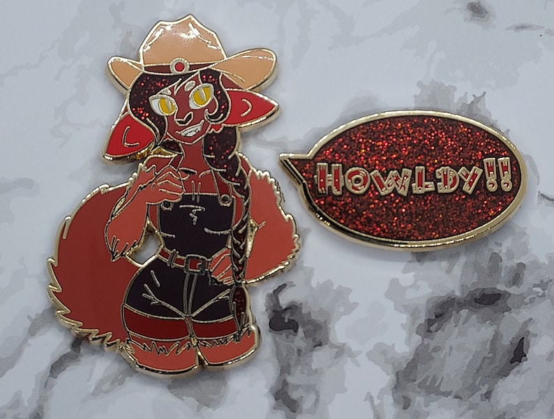 May include: A red and gold enamel pin featuring a cartoon character wearing a cowboy hat and overalls. The character has a red tail and a speech bubble that says "HOWLDY!!".