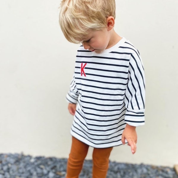 A soft, 100% cotton, kids’ Breton striped sweatshirt with a personalised appliqué embroidered initial or felt number of your choice.