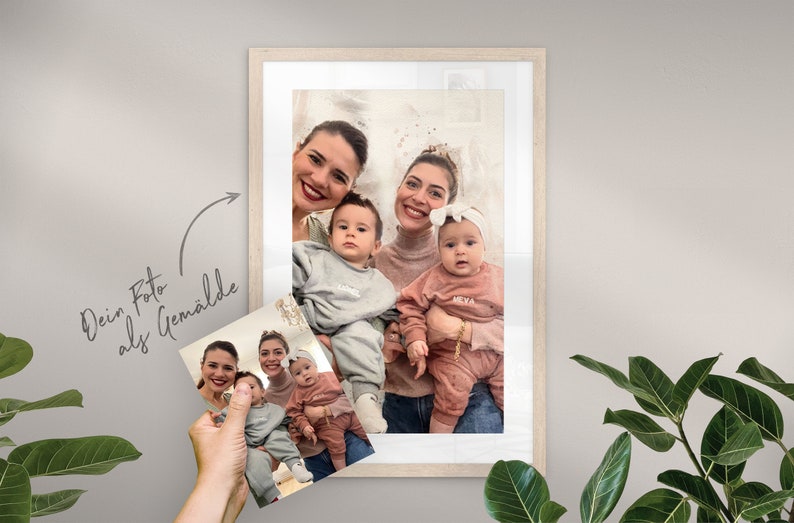 May include: A framed photo of two women and two babies. The women are smiling and holding the babies. The babies are wearing matching outfits with their names on them. The photo is in a white frame with a white mat.