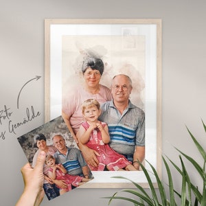 May include: A watercolor painting of a family portrait. The painting features a grandmother, grandfather, and a young girl. The grandmother is wearing a pink shirt, the grandfather is wearing a blue and white striped shirt, and the girl is wearing a pink dress. The painting is framed in a light wood frame.