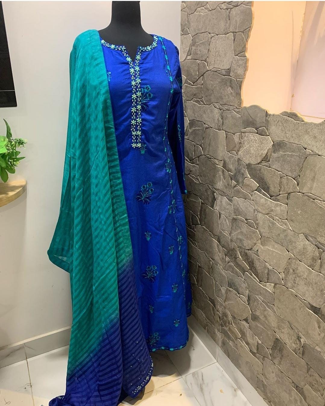 royal blue silk dress pakistani Experience the timeless elegance of Angrakha style Pishwas, expertly crafted in royal blue silk and adorned with golden embellishments. With its rich and luxurious design, this piece radiates an air of royalty
