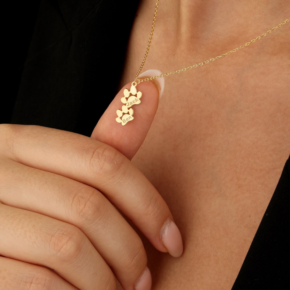 Personalized Paw Print Name Necklace shown in gold.