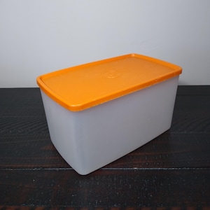 May include: A white ceramic mug with a black handle and the text "But First, Coffee" in a black, bold font. The mug is on a white surface.