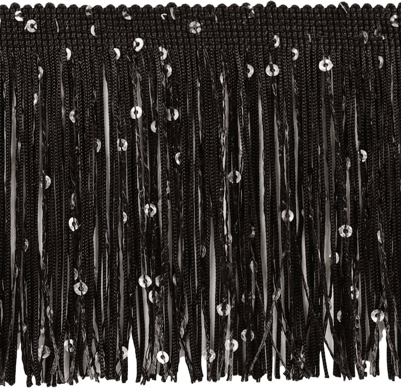 May include: Black fringe trim with silver sequins. The trim features a woven top edge and long, dangling strands. The sequins are evenly spaced along the strands, adding a touch of sparkle. This trim is suitable for various craft and sewing projects.
