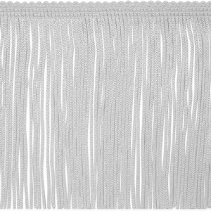 May include: Close-up of a white fringe trim. The trim features a woven top edge with a scalloped design and long, vertical strands of fringe. The fringe is a soft, light color, suitable for various craft and design projects.