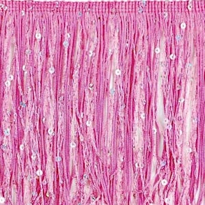 May include: Close-up of a pink fringe trim with a dense, textured appearance. The trim is made of long, vertical strands of pink material, interspersed with small, shimmering sequins. The fringe is likely used for embellishing clothing or accessories.