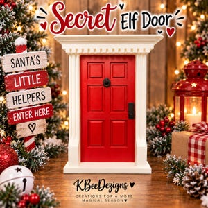 May include: A miniature red door with a white frame and black hardware, featuring a central knocker and handle. Above the door, the text reads Secret Elf Door. Below, the text reads KBeeDezigns Creations for a more magical season.
