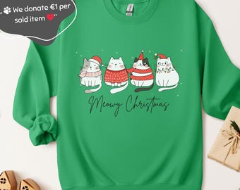 May include: Green sweatshirt featuring a graphic of four cats in festive attire. The cats are wearing hats, scarves, and sweaters, with the words "Meowy Christmas" below. The sweatshirt is a solid green color.