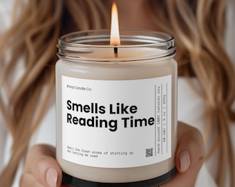 May include: A beige candle with a black label that reads "#Viral Candle Co. Smells Like Reading Time" and "Smell the fresh aroma of shutting up and letting me read". The candle is hand-poured with 100% natural soy wax and has a burn time of 50-60 hours.